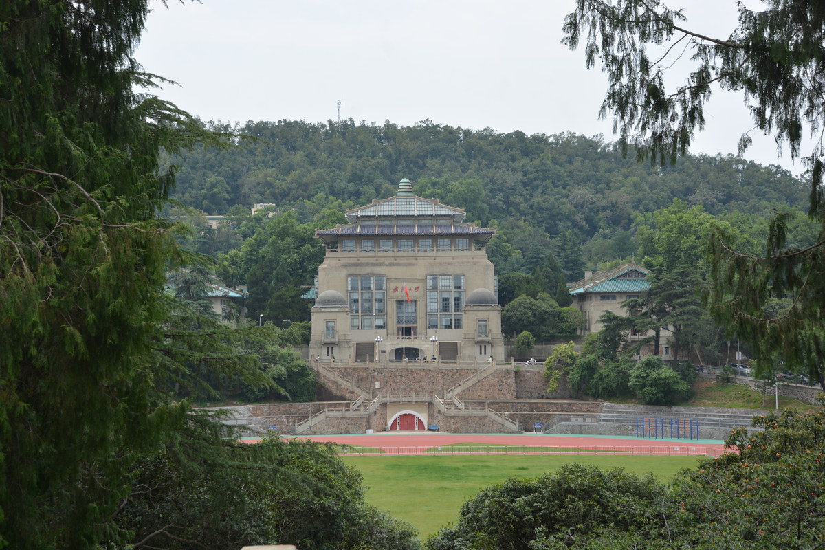 Historic campus architecture and green hills at Wuhan University (2025).